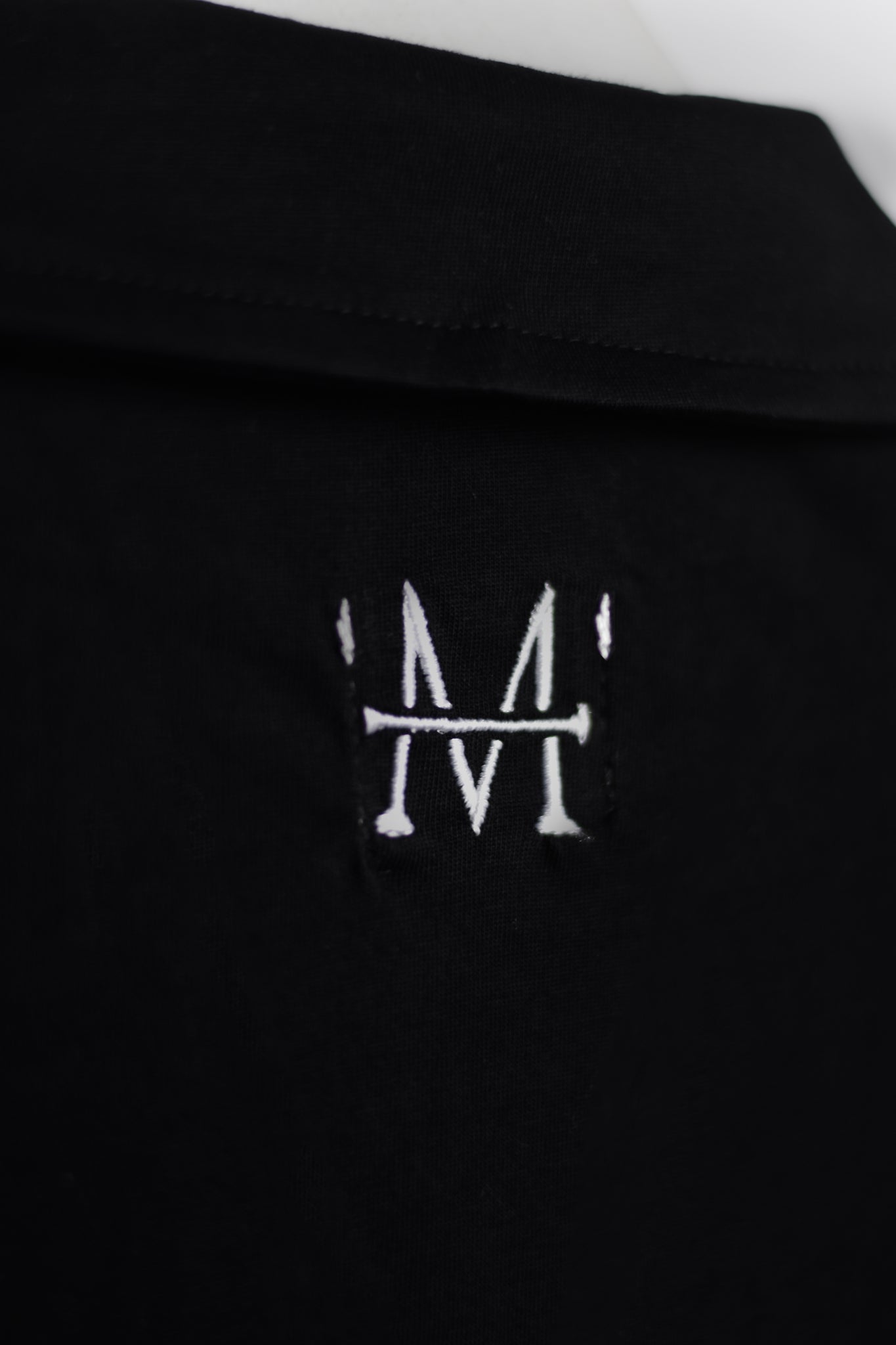 Load image into Gallery viewer, Black shirt with a white embroidered logo